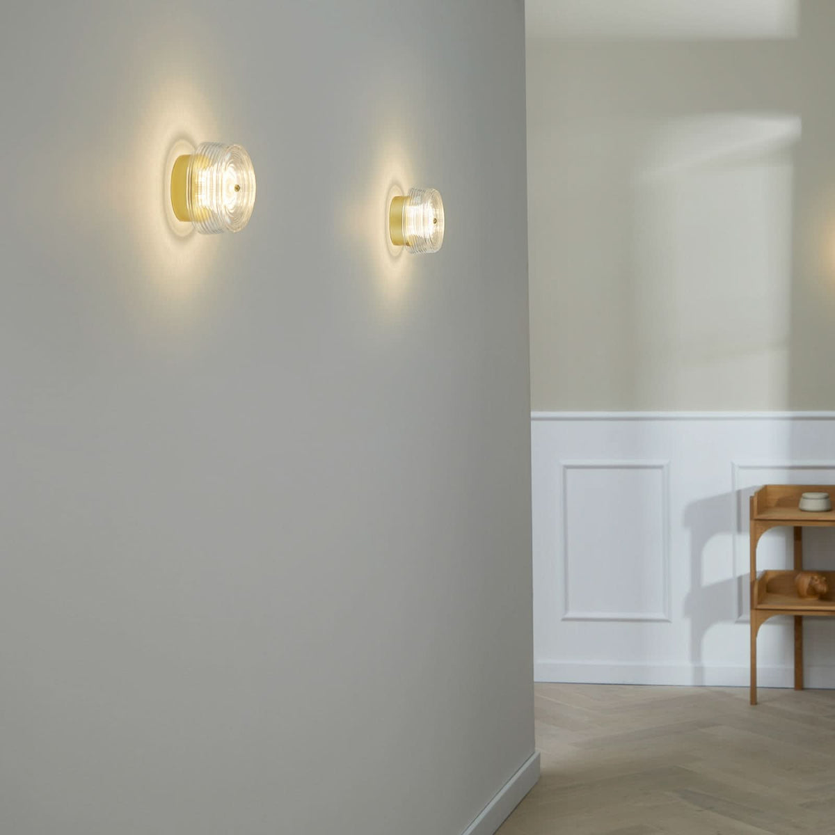 Applique murale LED Glow en acier, doré mat et transparent, Ø 16 cm