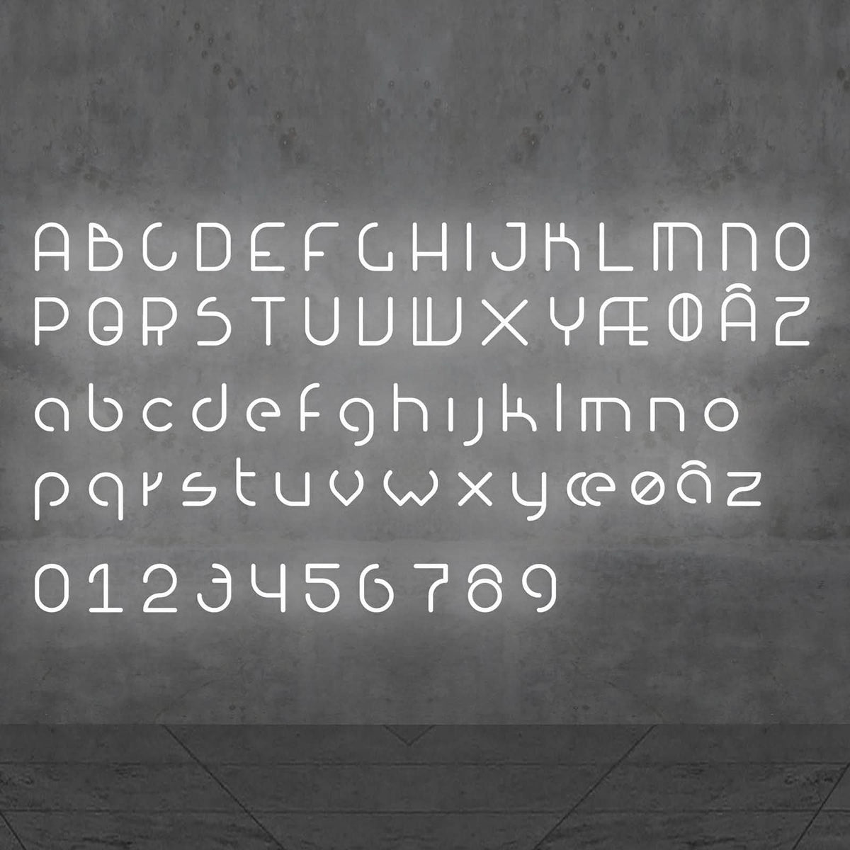 Alphabet complet en lettres lumineuses blanches présenté sur un fond gris.