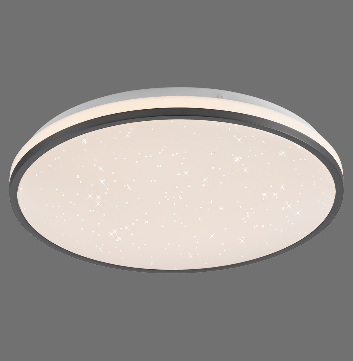 Plafonnier rond noir vu de face, diffuseur laiteux parsemé de petits points lumineux