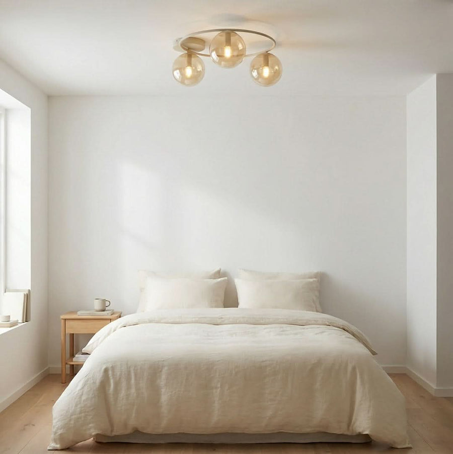 Plafonnier beige installé dans une chambre épurée, au-dessus d'un lit, lumière chaude.