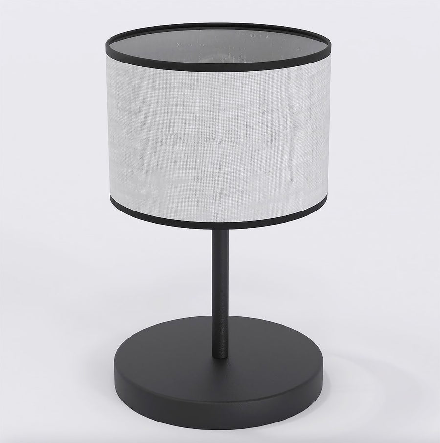 Lampe à poser vue de face, abat-jour cylindrique en tissu gris bordé de noir