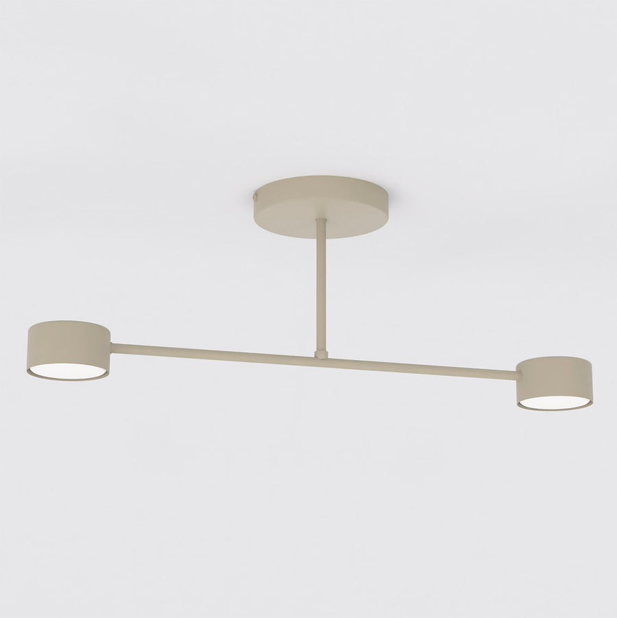 Plafonnier beige à deux têtes cylindriques vu de face sur fond blanc