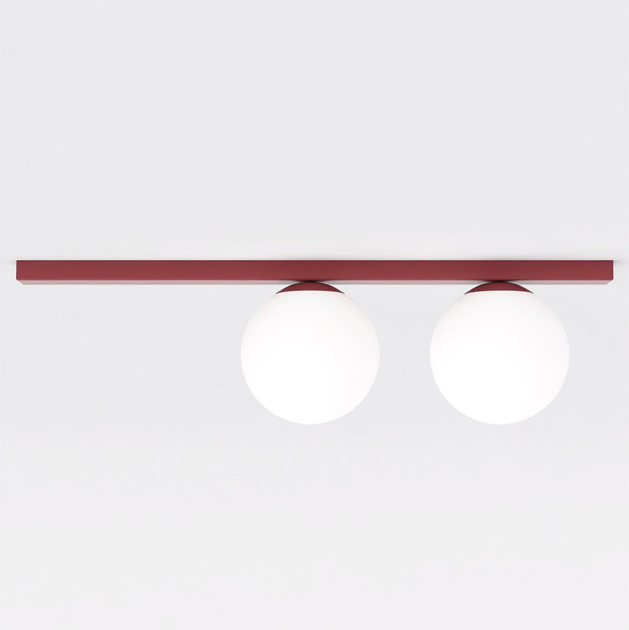 Vue de face du plafonnier à deux globes de verre blanc sur barre fine