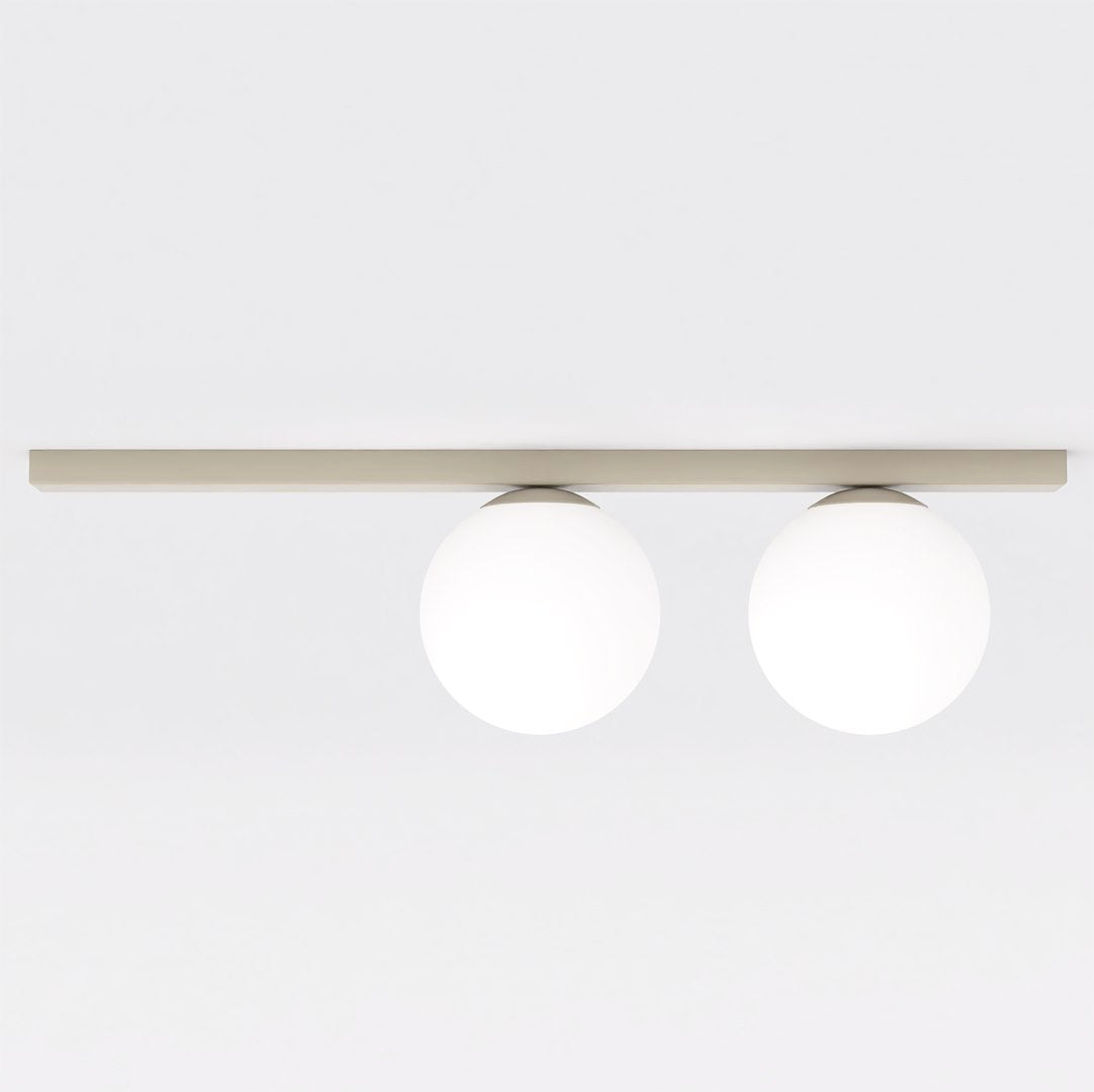 Vue de face : deux globes de verre blanc fixés sous une barre plate beige