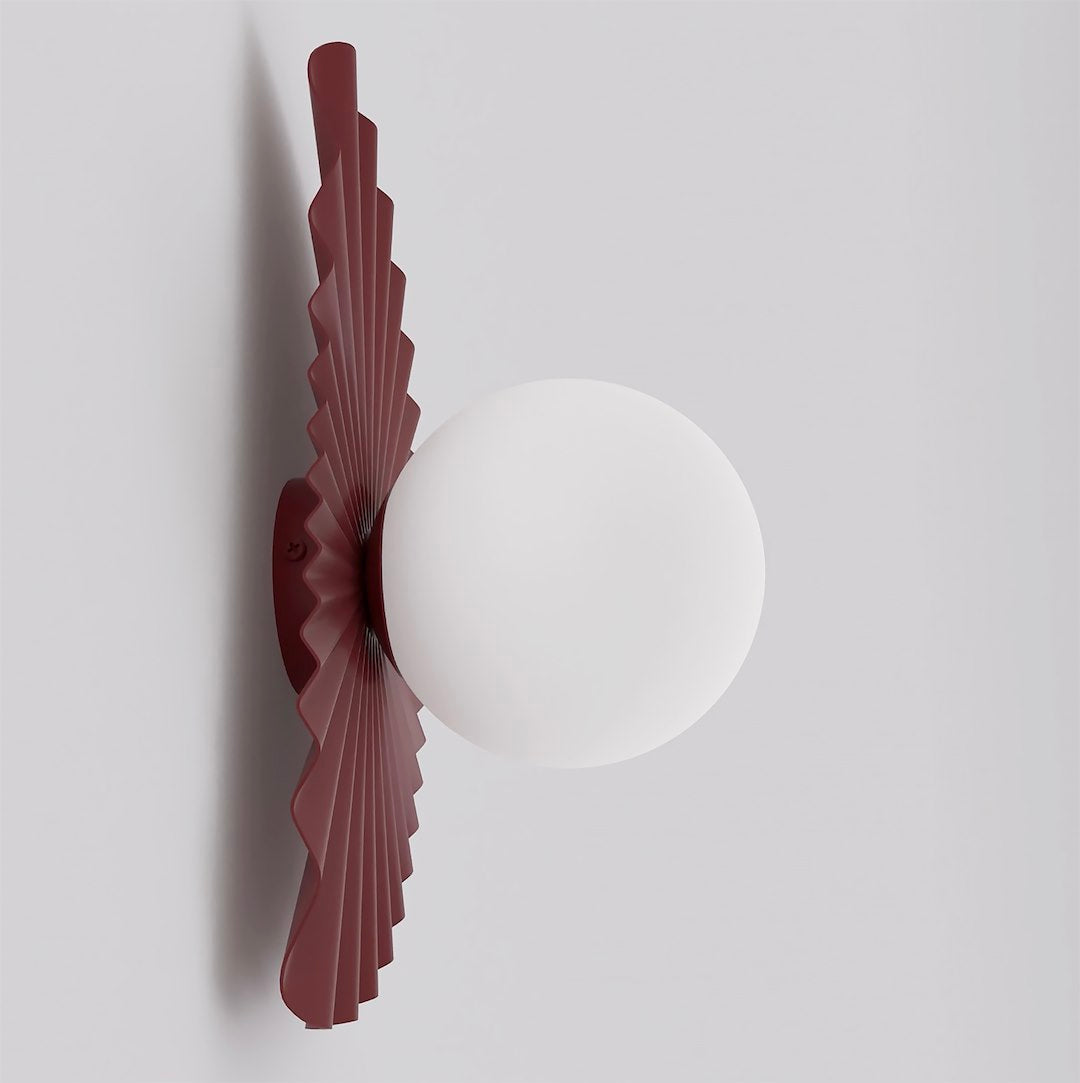 Profil de l'applique bordeaux montrant l'épaisseur du plissé et le globe blanc.