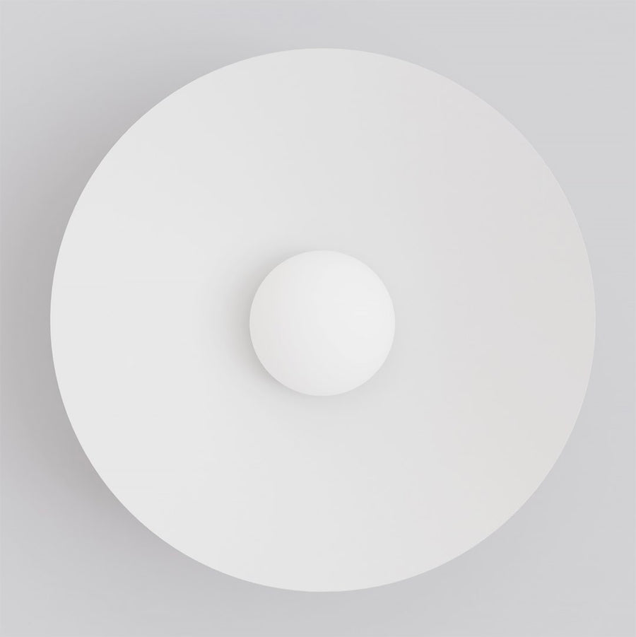Face avant, grand disque blanc et petite sphère centrale éclairée