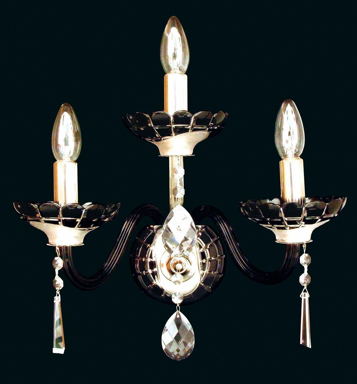 Applique murale dorée à trois bras courbés, bougies et pendentifs en cristal facetté sur fond noir