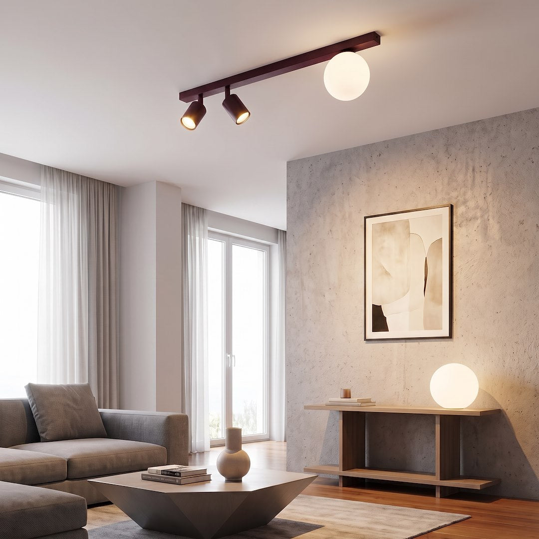 Mise en ambiance du plafonnier dans un salon moderne, mur béton et canapé gris