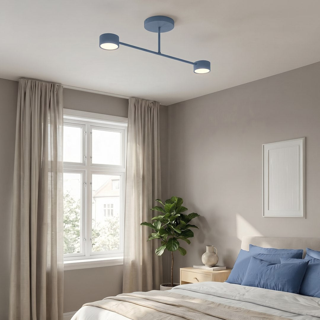 Mise en ambiance dans une chambre, plafonnier bleu au-dessus du lit