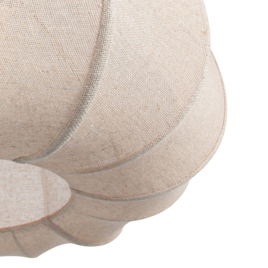 Détail du tissu beige clair et des coutures verticales du diffuseur