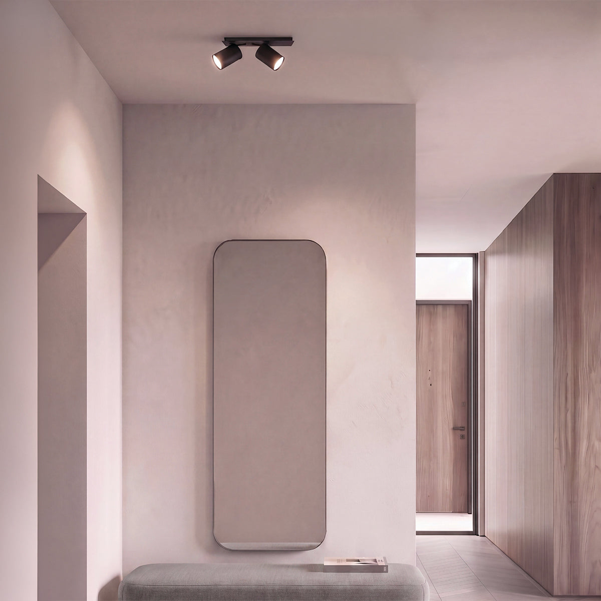 Spot double noir mat fixé au plafond dans un couloir clair avec miroir