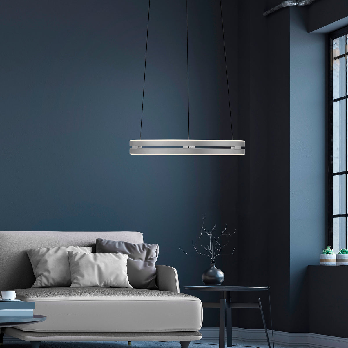 Mise en ambiance du luminaire suspendu au-dessus d'un canapé dans un salon bleu