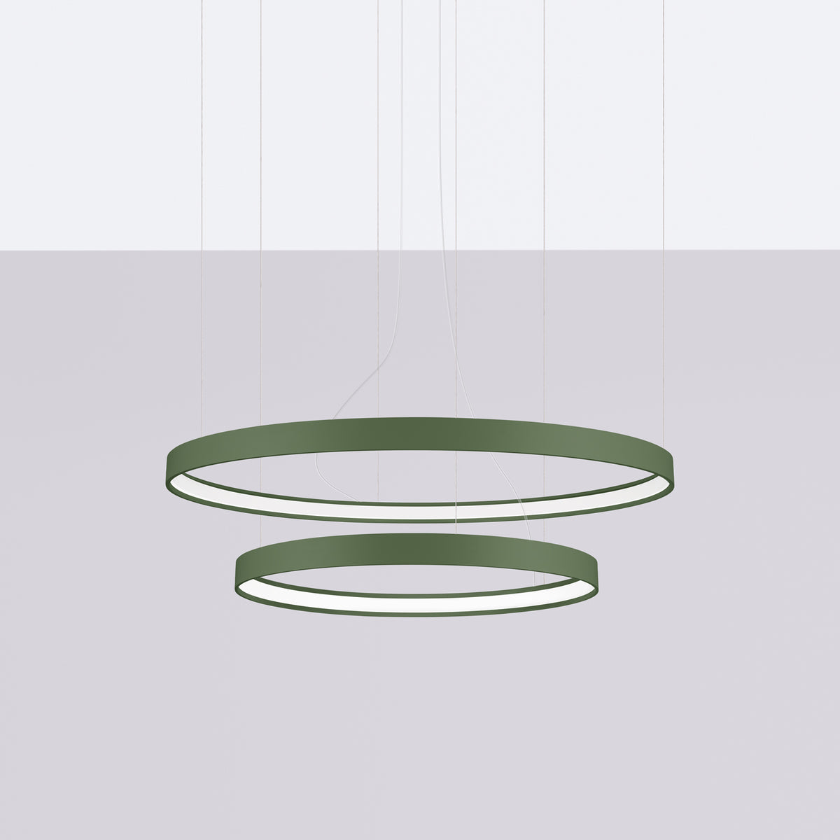 Vue du luminaire en situation, deux cercles verts suspendus au-dessus d'un fond gris.