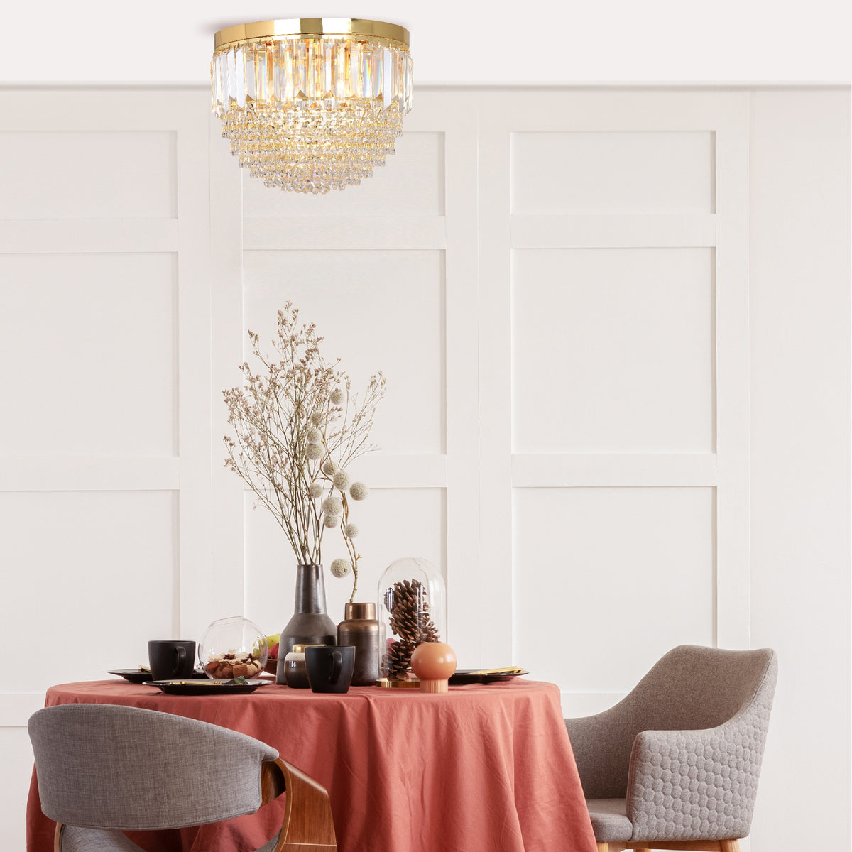 Mise en ambiance du luminaire suspendu au-dessus d'une table ronde dressée.