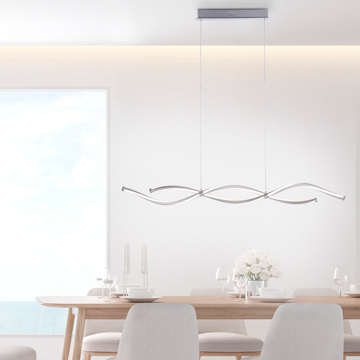Suspension allumée au-dessus d’une table de salle à manger lumineuse.