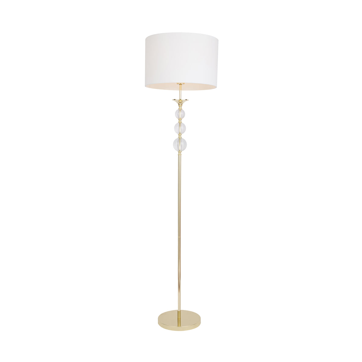 Lampadaire doré avec abat-jour blanc et trois boules de verre empilées.