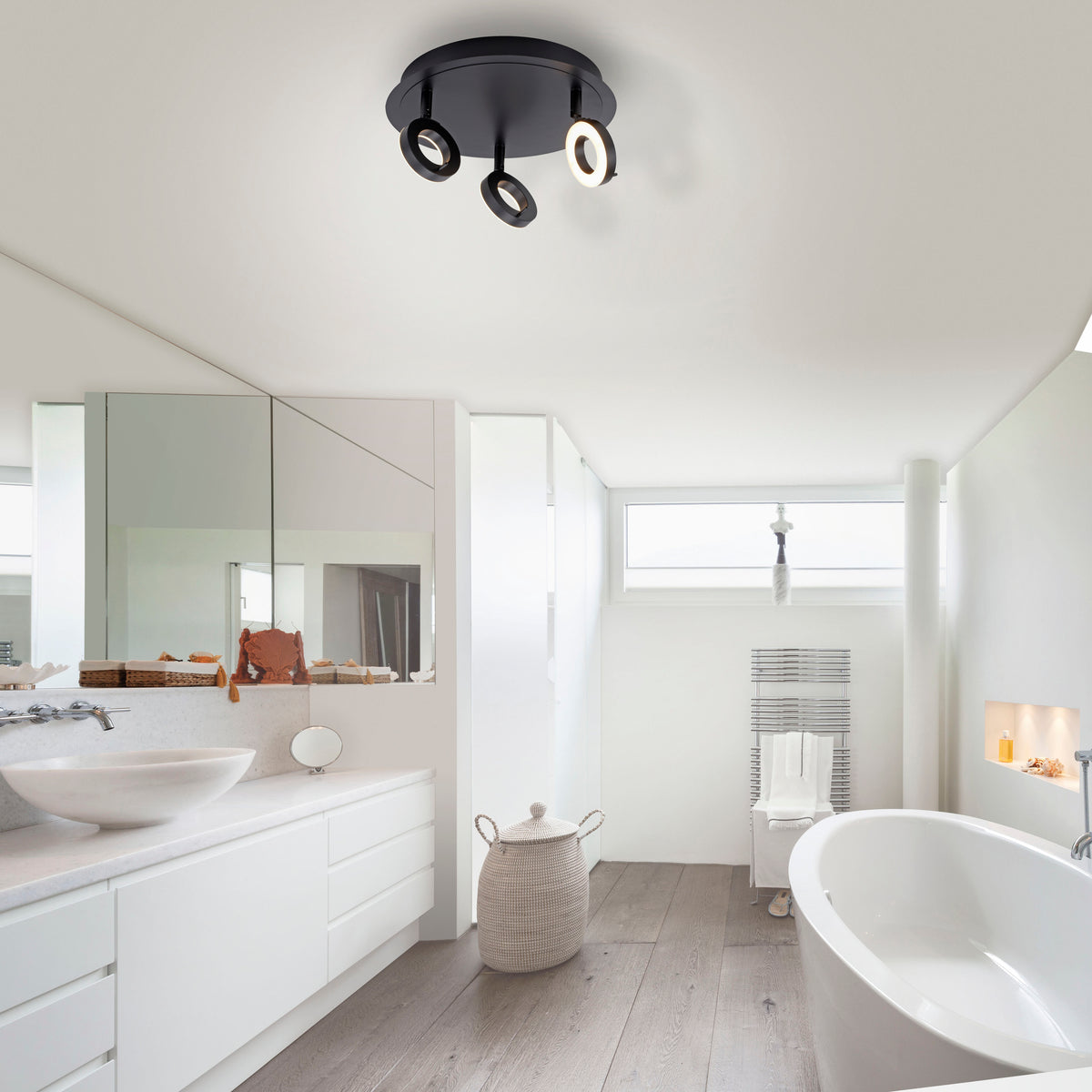 Mise en ambiance du plafonnier dans une salle de bain blanche avec baignoire et meuble