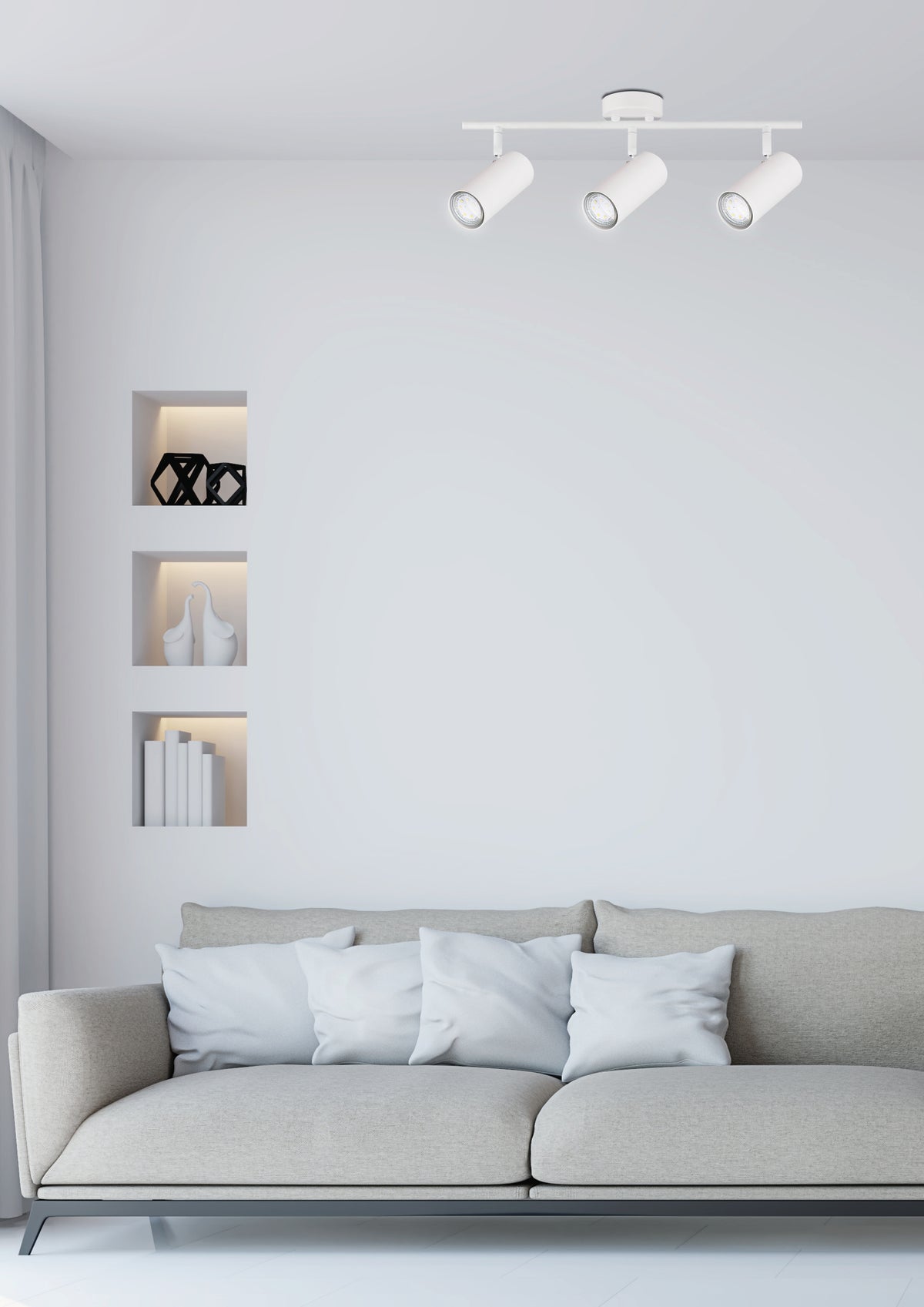 Mise en ambiance salon minimaliste, plafonnier blanc éclairant un canapé gris et niches murales