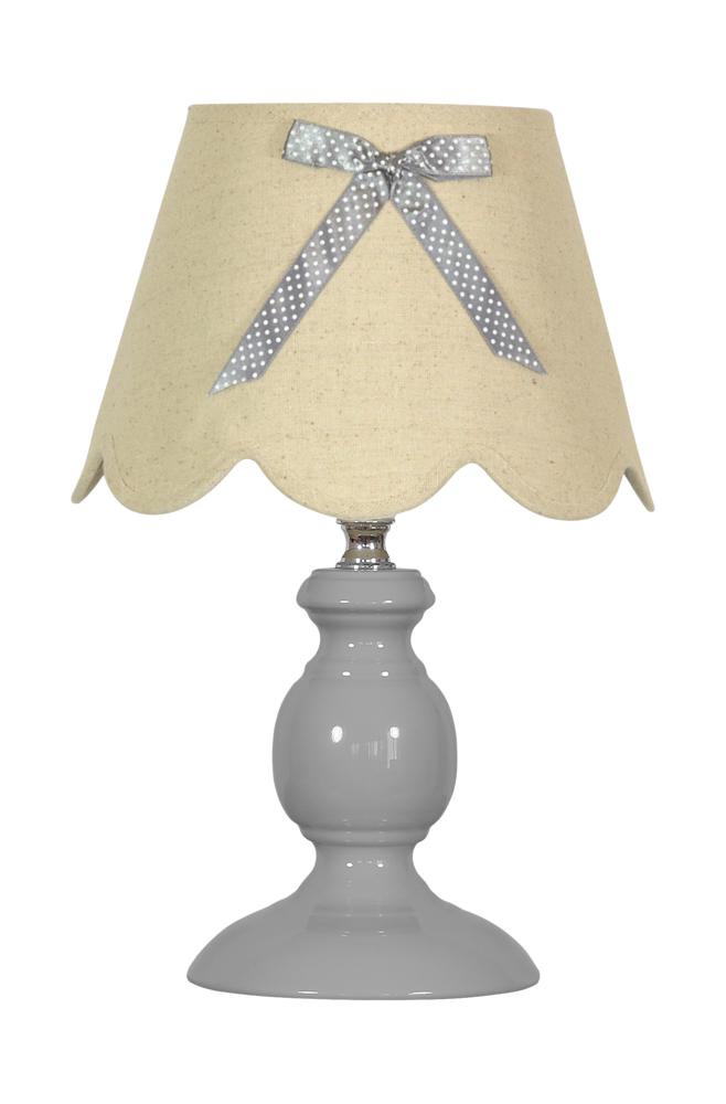 Lampe à poser de face, abat-jour beige à volants et nœud en ruban à pois