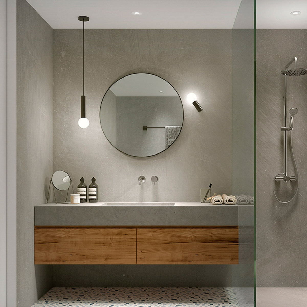 Salle de bain contemporaine avec applique près du miroir rond et suspension