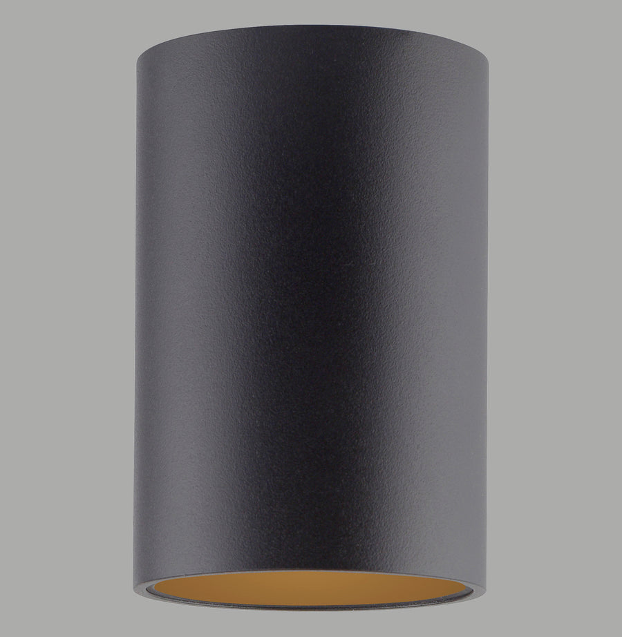 Vue de face d'un plafonnier cylindrique noir avec intérieur doré, sur fond gris uni.