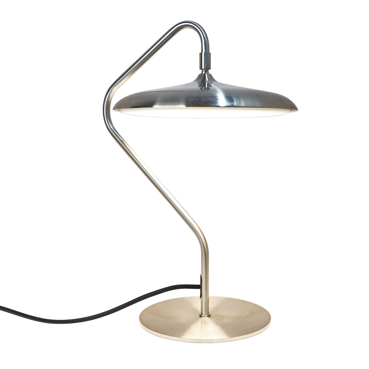 Lampe à poser de profil, abat-jour métallique et bras tubulaire courbé sur fond blanc.
