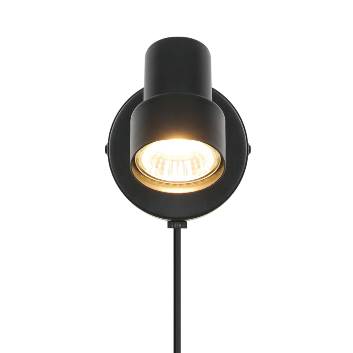 Face avant du spot allumé, ampoule chaude dans la tête cylindrique.