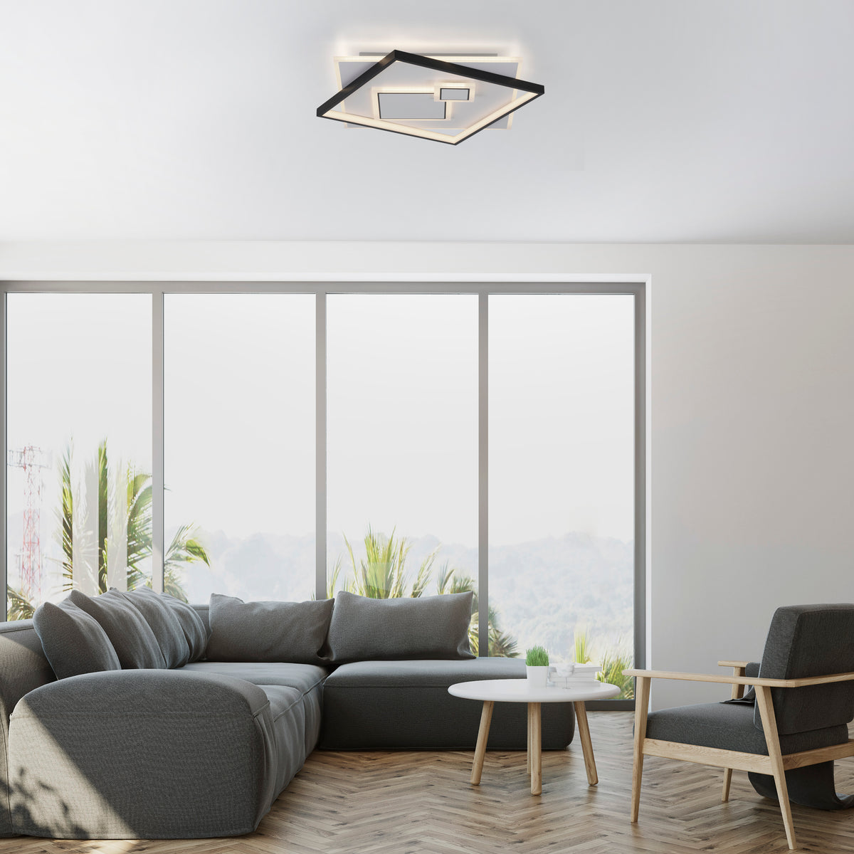 Mise en ambiance dans un salon moderne avec canapé gris et baies vitrées