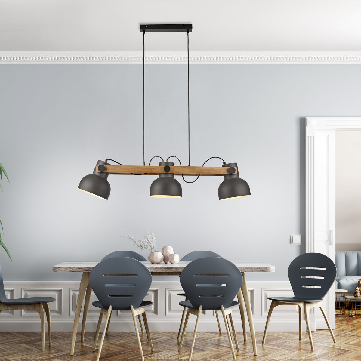 Mise en ambiance au-dessus d'une table de salle à manger avec chaises grises et décorations.