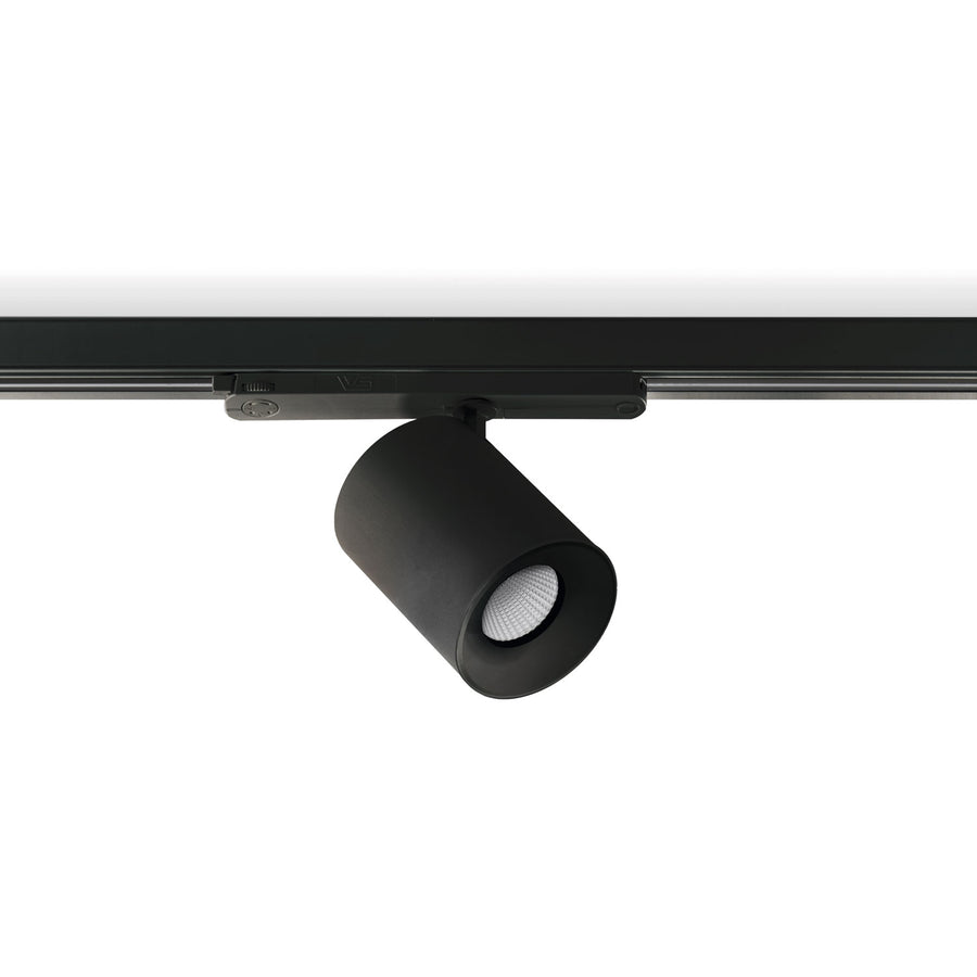 Version noire du spot sur rail, inclinée, avec lentille LED visible.