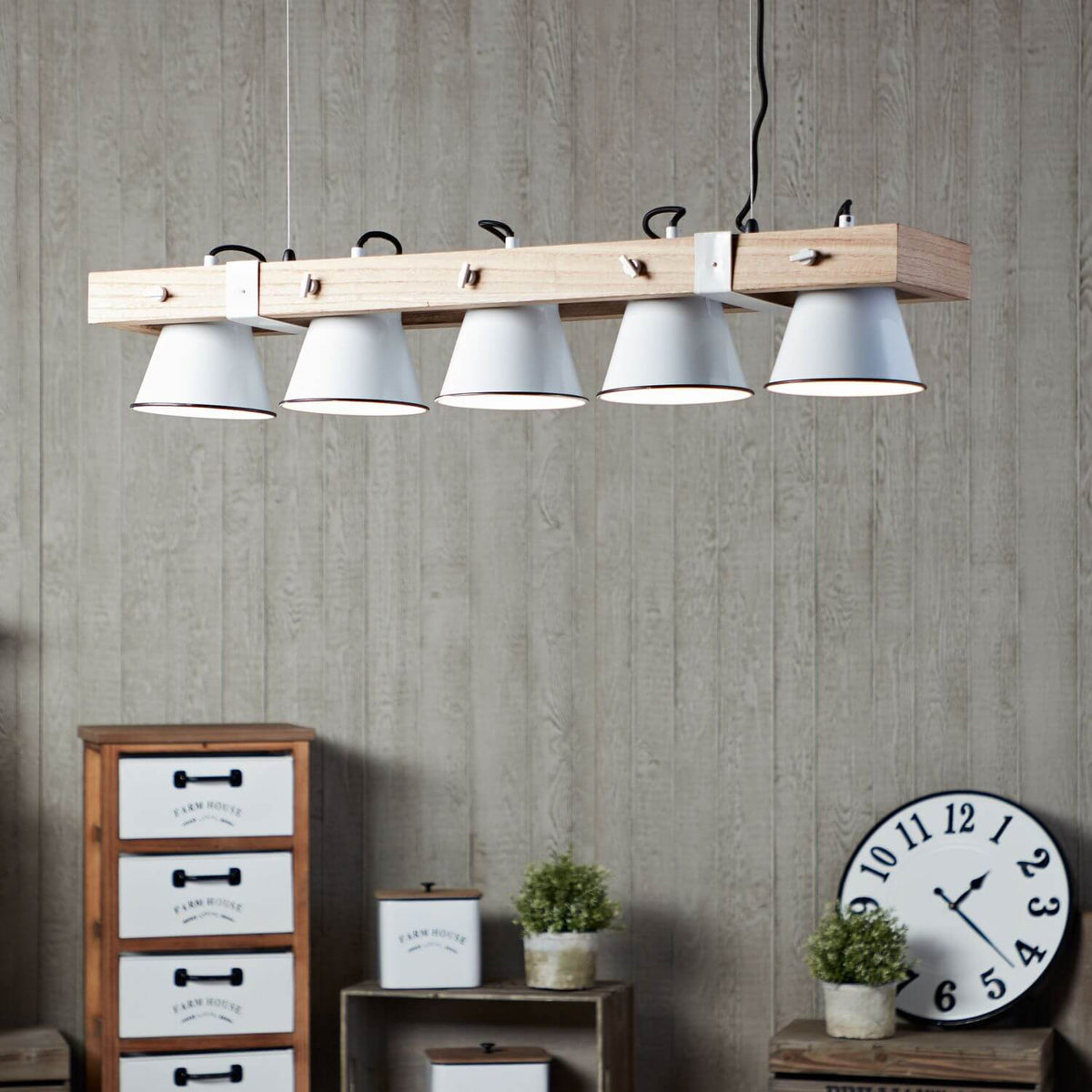 Mise en ambiance campagne avec horloge murale, commode et petits pots de verdure
