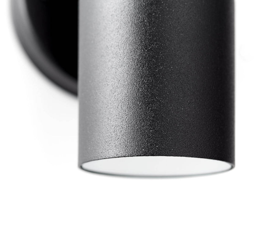 Détail du bas du cylindre avec verre blanc et finition noire.
