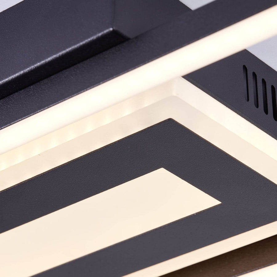 Détail rapproché de la finition : bord noir mat, diffuseur blanc et grille d'aération.