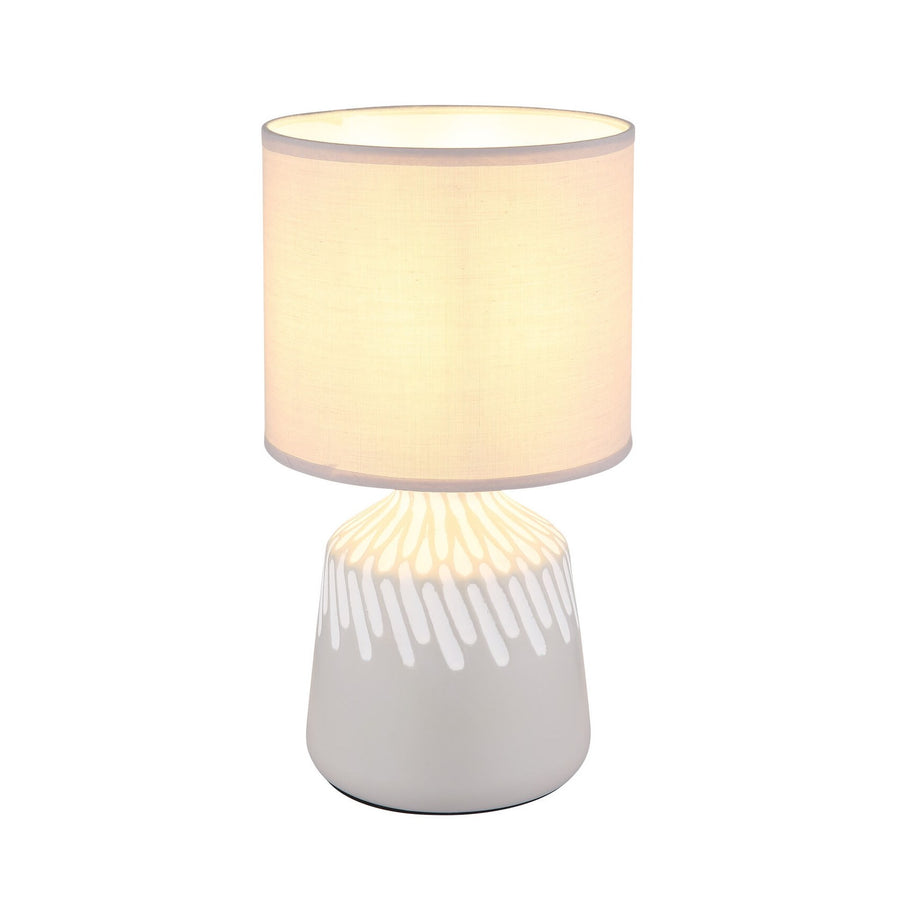 Lampe à poser de face avec abat-jour cylindrique beige et pied céramique clair