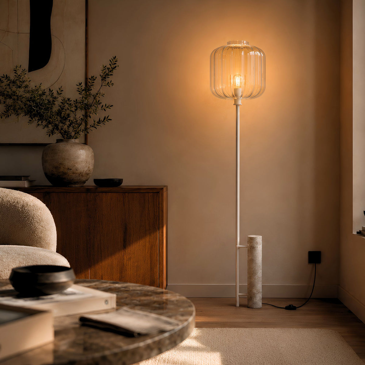 Vue de face du lampadaire, verre transparent allumé, posé près d'une console en bois sombre