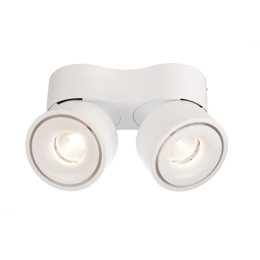 Spot double blanc de face, deux têtes rondes orientables allumées.