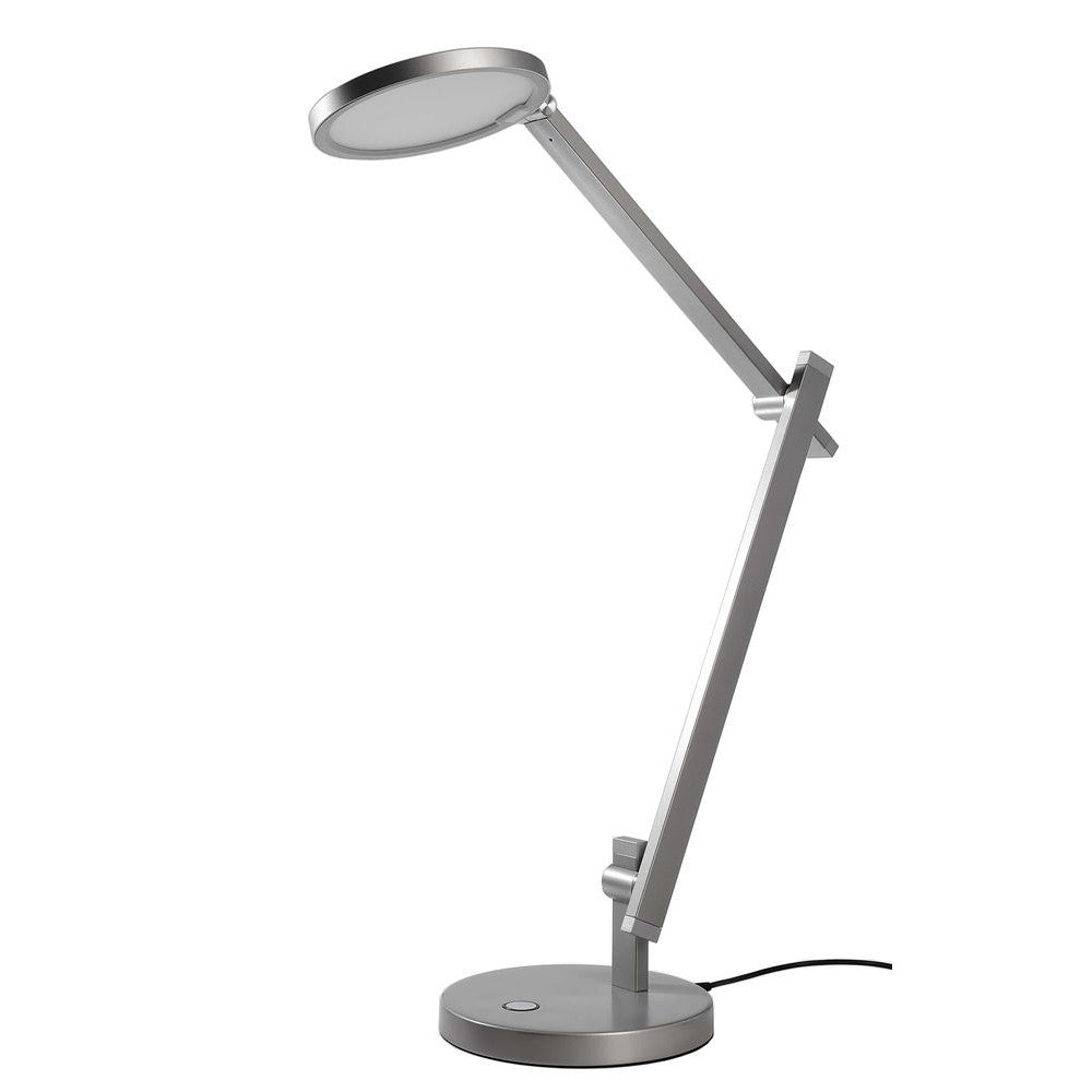 Lampe à poser argentée, tête ronde et bras articulé, vue de profil sur fond blanc