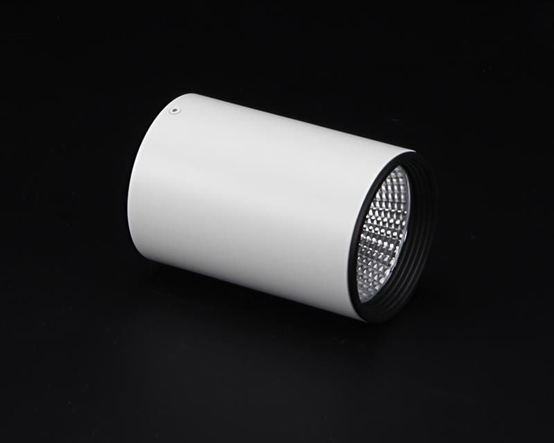 Spot cylindrique blanc présenté de trois quarts sur fond noir, réflecteur visible.