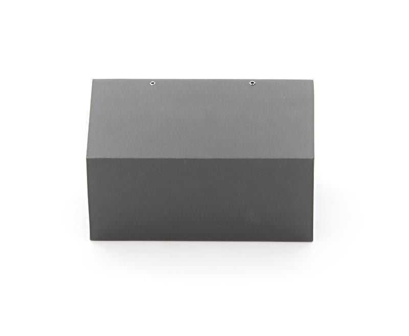 Vue de dessus du boîtier gris rectangulaire, avec deux vis alignées sur le bord.