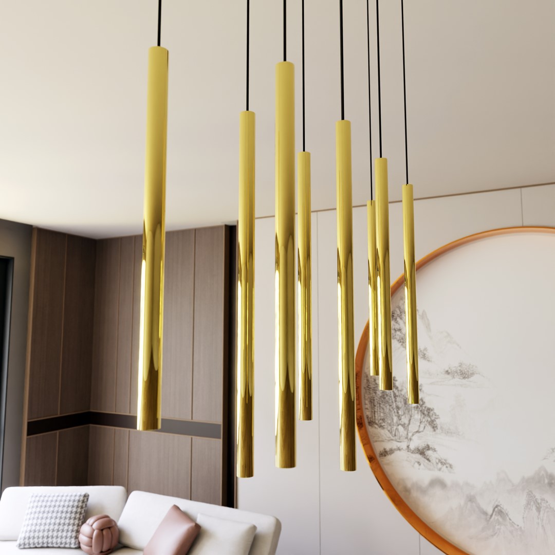 Gros plan sur les tubes dorés brillants et leurs câbles noirs, dans un intérieur clair.
