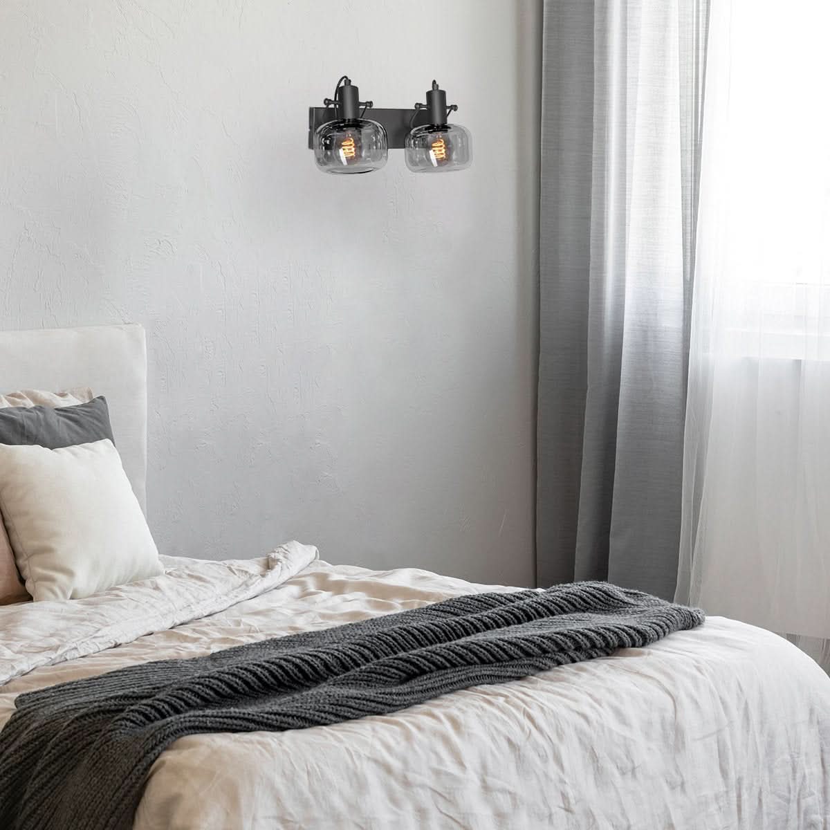 Mise en ambiance dans une chambre, applique fixée au mur au-dessus du lit