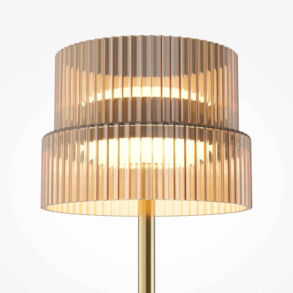 Gros plan sur l'abat-jour en verre strié ambré, lumière chaude allumée à l'intérieur.