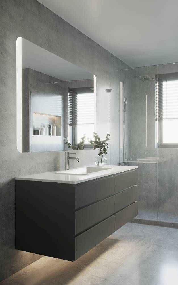 Vue d'ambiance dans une salle de bain moderne, miroir allumé au-dessus d'un meuble noir.