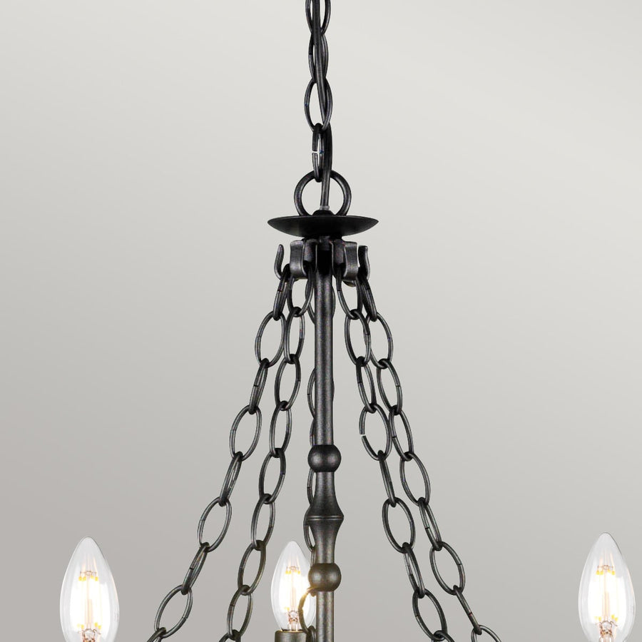 Détail de la suspension avec chaîne, tige centrale et coupelle de fixation au plafond.