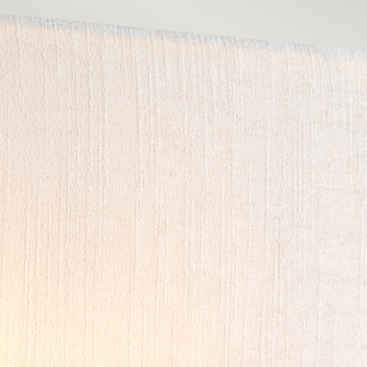 Détail rapproché du tissu crème de l'abat-jour diffusant une lumière chaude