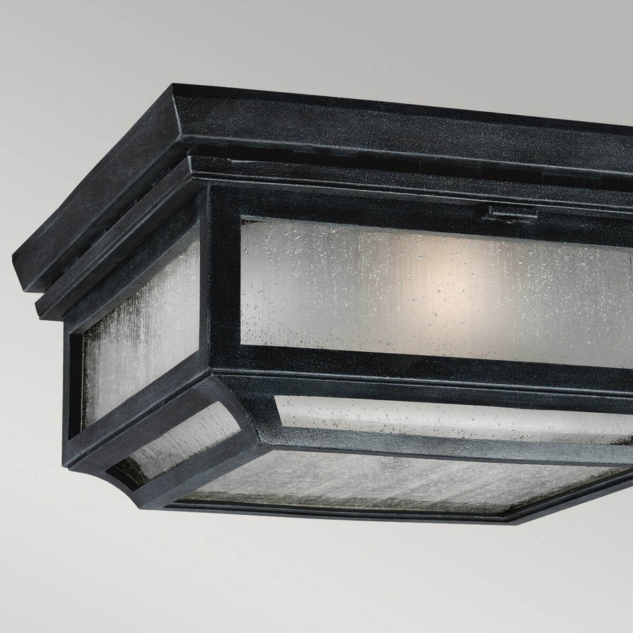Détail du cadre métallique noir martelé et du verre granité illuminé
