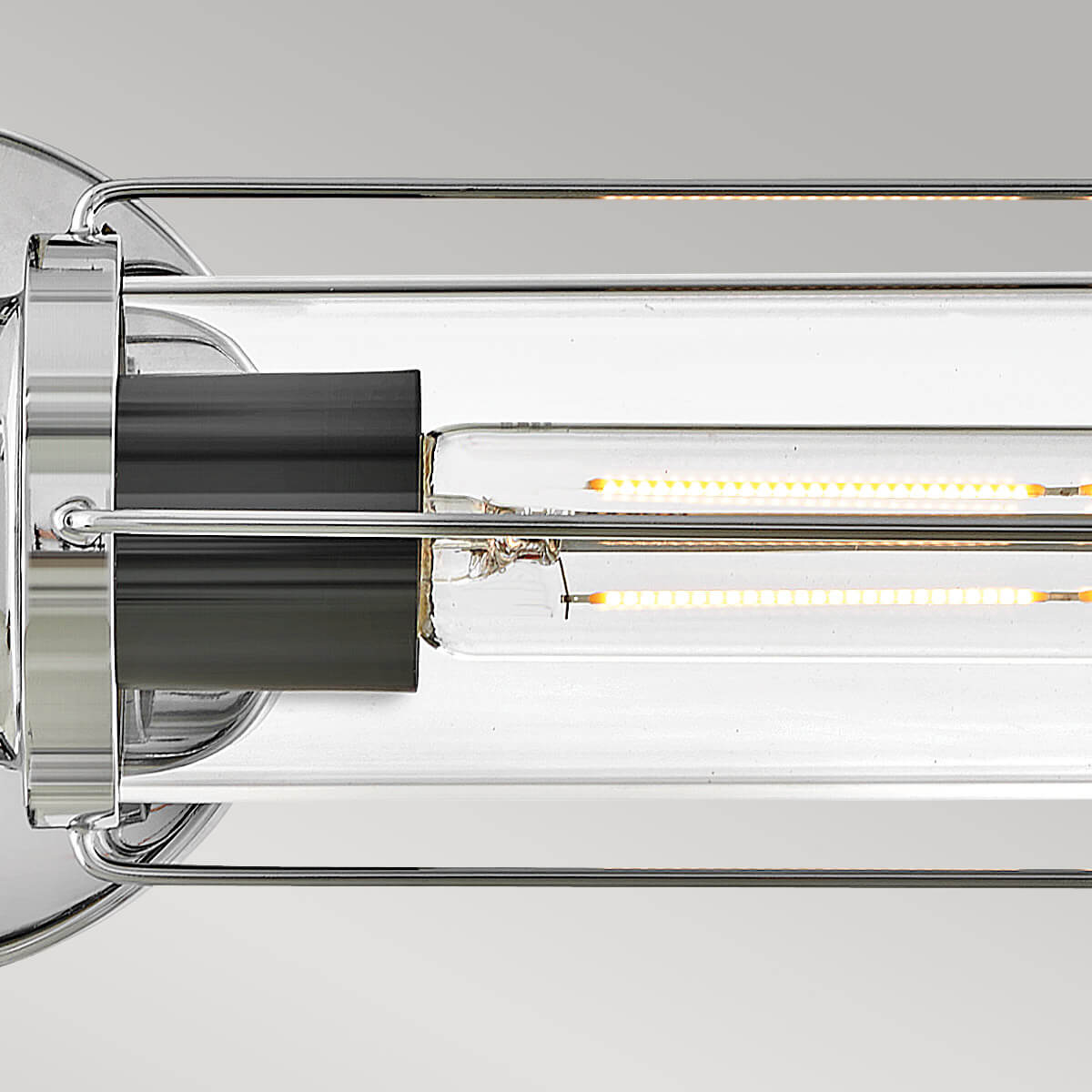 Détail de l'ampoule LED filament allumée dans le tube de verre transparent.