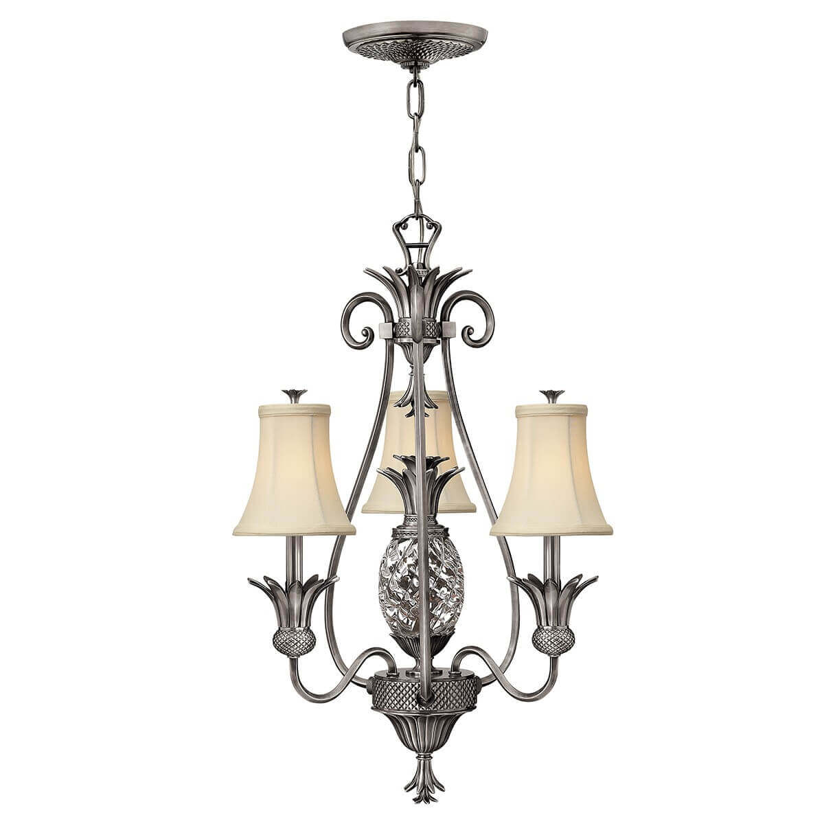Lustre complet à quatre lumières avec abat-jours beiges et verre central en forme d'ananas.