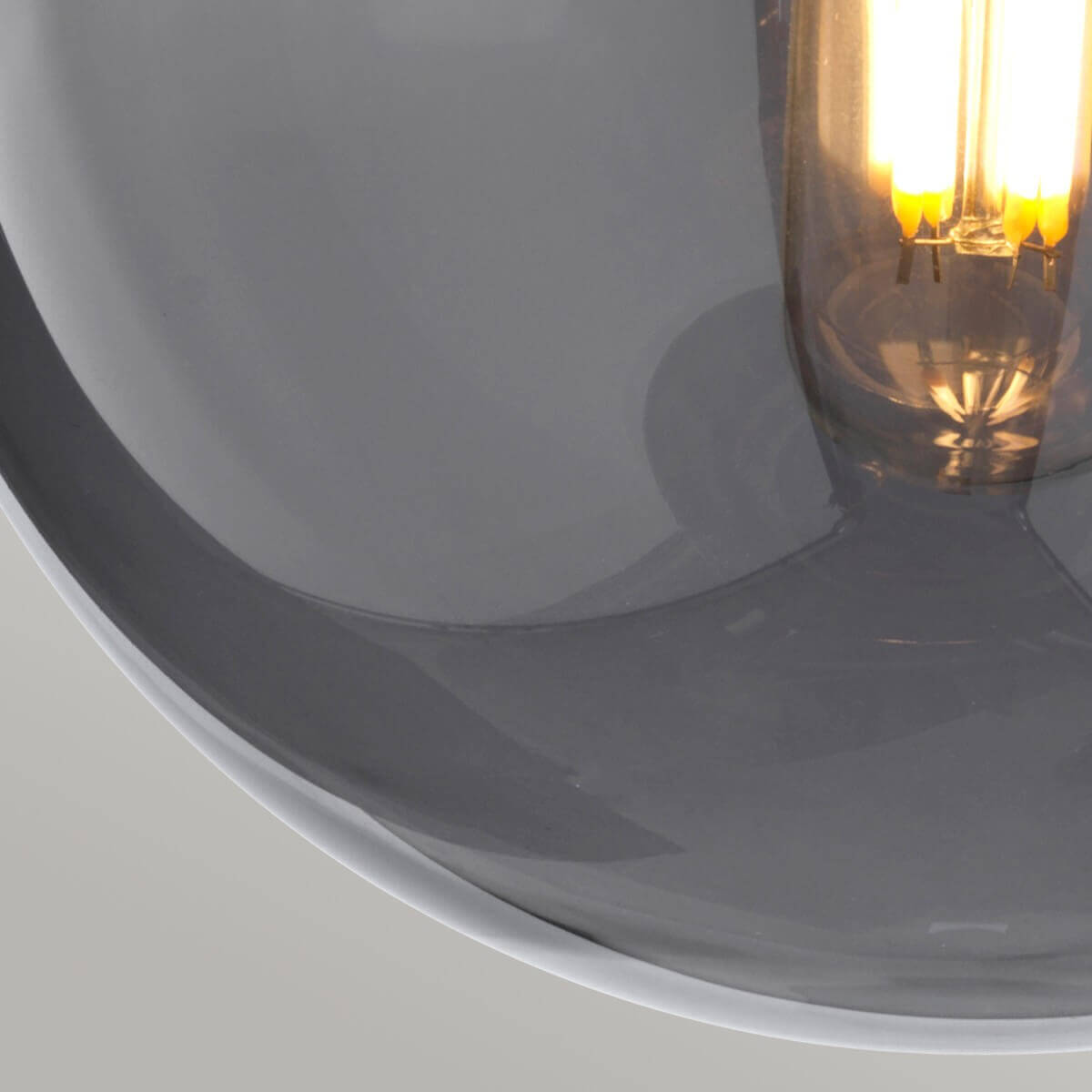 Détail du globe de verre et de l'ampoule à filament allumée