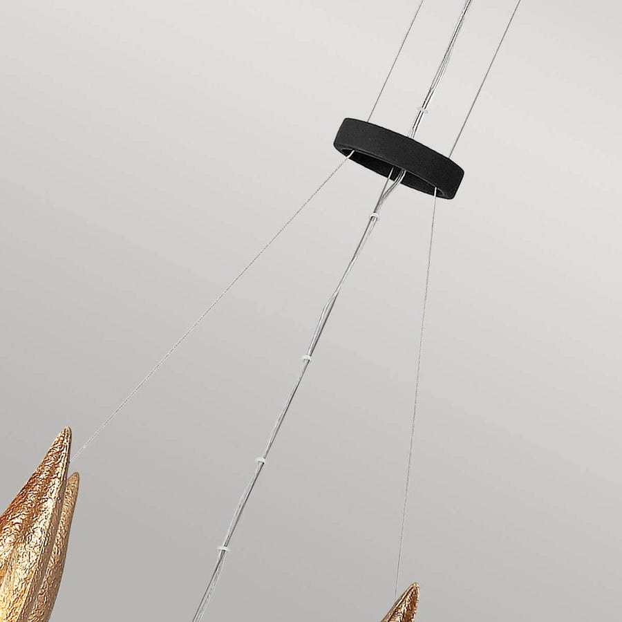 Détail de la suspension : câbles tendus, anneau noir et tendeurs de réglage